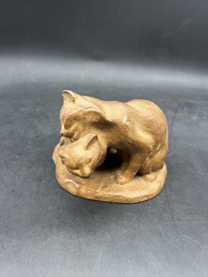 an image of a small statue of a cat on a plate