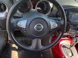 dashboard of a small car with a steering wheel and dashboard controls