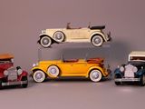 several toy cars are stacked on top of each other on a table