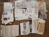 many different types of stamps and envelopes laid out on the floor
