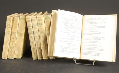 several old books stacked on top of each other on a table