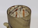 a glass cup with a handle on a white surface