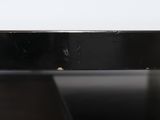 close up of a black table with a white wall in the background