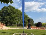 a large blue pole in the middle of a park