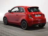a red smart car parked on a checkered floor in a room