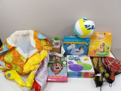 a table with toys, books, and a beach ball on it