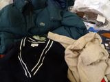 a pile of clothing that is sitting on a bed