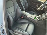 the interior of a silver car with black leather seats and a steering wheel