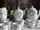 several cups and saucers are lined up on a table