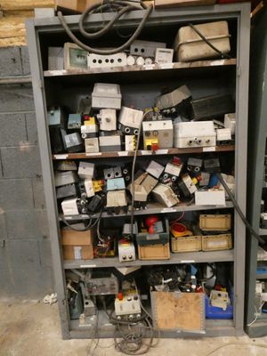 a shelf full of electronic equipment in a room