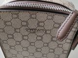 beige and brown handbag with a brown strap hanging from it ' s side
