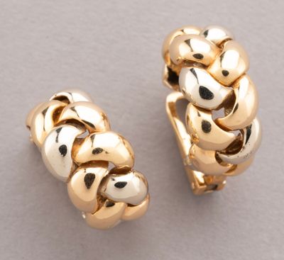 two pairs of gold plated hoop earrings on a white surface