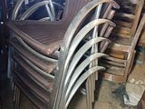 a lot of chairs that are stacked up in a room