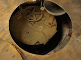 a clock that is sitting in a hole in the floor