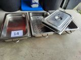 three stainless steel trays with lids and lids are on the ground
