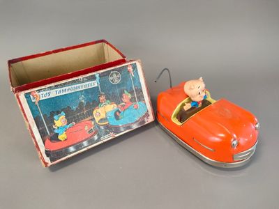 an orange toy car and a box with a pig on it