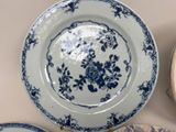 a lot of blue and white plates that are on the table