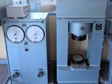 two machines that are sitting next to each other in a room
