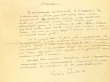 un vieux document sur lequel figure une lettre manuscrite, posé sur une table