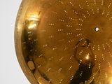 a gold clock with a man in the middle of it