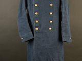 a blue military coat with gold buttons and a red collar