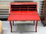 a red desk with a red top in a room
