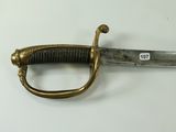 a very old sword that is laying on the table