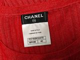 a close up of a label on the back of a red sweater