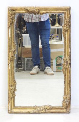 a woman standing in front of a mirror taking a selfie