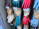 many different colored gloves on display in a store