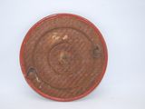 a red plate on a white table with a white background