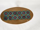 a picture of a wooden plate with a design on it