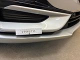 a close up of the front of a car with a sticker on it