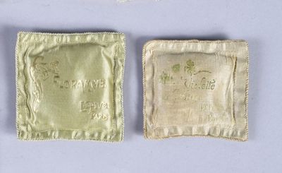two pieces of cloth with a small bag on top of it