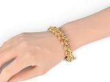 a close up of a person ' s hand wearing a gold chain bracelet