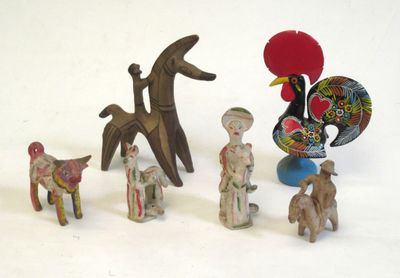 many figurines of different shapes and sizes on a white surface