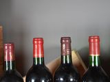 several bottles of wine are lined up in a row on a table