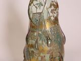 a glass vase with a gold and green design on it