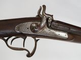 a close up of a gun with a metal handle on a white background