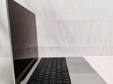 a laptop that is sitting on a white surface