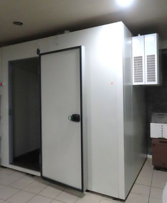 a room with a microwave, microwave oven, and refrigerator in it