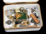 a white box filled with assorted items on a black surface