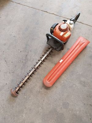 a picture of a hedger and a tool on the ground