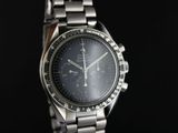 a close up of a watch on a black background