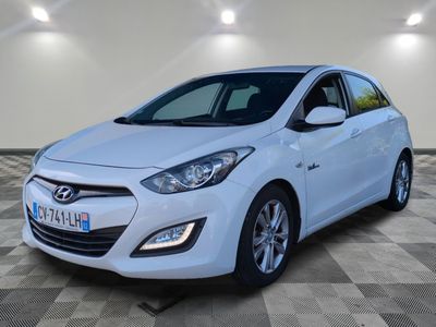 une voiture blanche est garée sur le sol à carreaux d'un garage