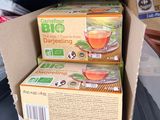 two boxes of green tea sit on a shelf in a store