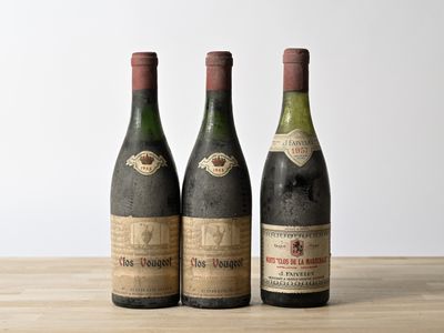 three bottles of wine sitting on top of a wooden table