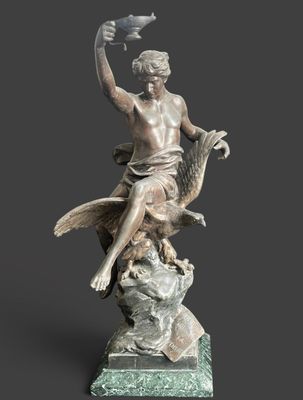 a statue of a woman sitting on a rock with a bird in her hand