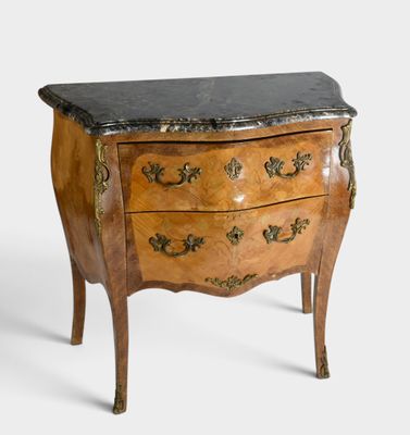a small chest of drawers with a marble top