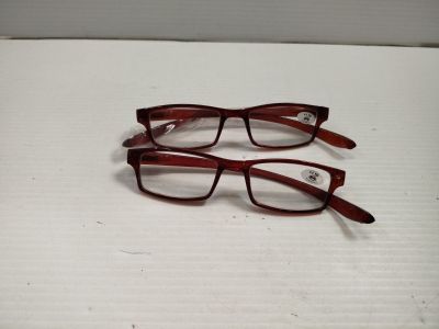 two pairs of glasses sitting on top of a box